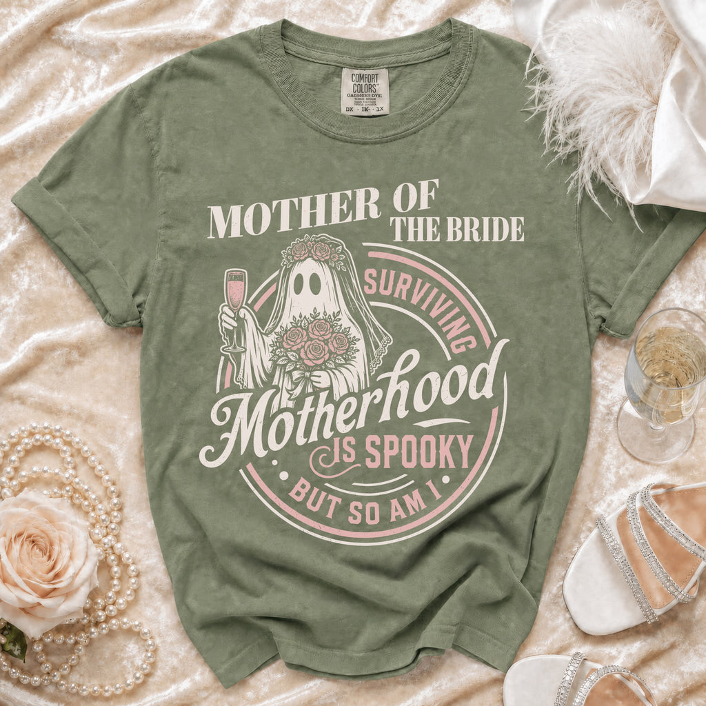 Green t-shirt with "Mother of the Bride Surviving Motherhood is Spooky But So Am I" text.