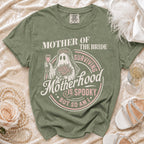 Green t-shirt with "Mother of the Bride Surviving Motherhood is Spooky But So Am I" text.