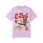 Pink t-shirt with "Her Last Rodeo" text and cowboy boot graphic.