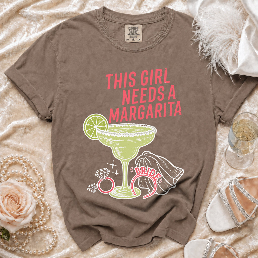Brown t-shirt with "This Girl Needs a Margarita" graphic and margarita glass.