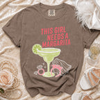 Brown t-shirt with "This Girl Needs a Margarita" graphic and margarita glass.