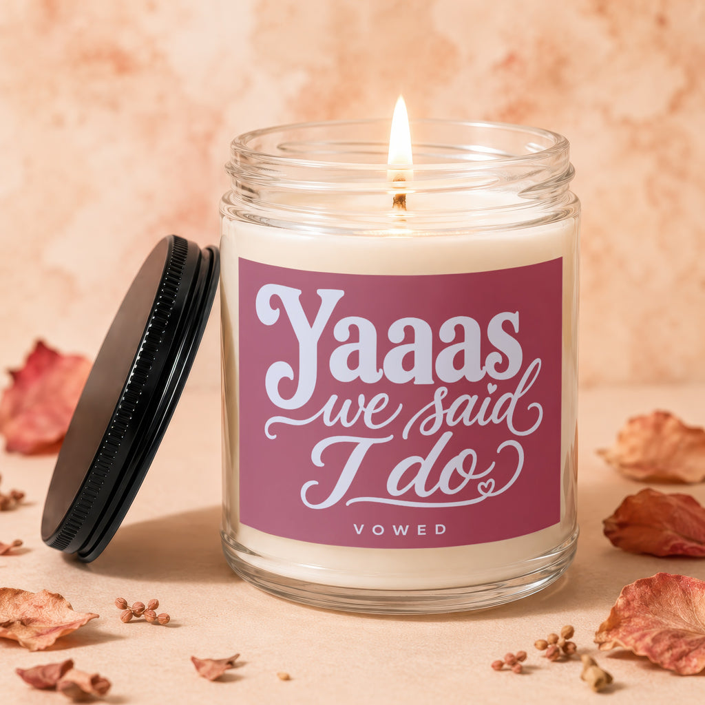 Lit candle with "Yaaas we said I do" text on a pink label.