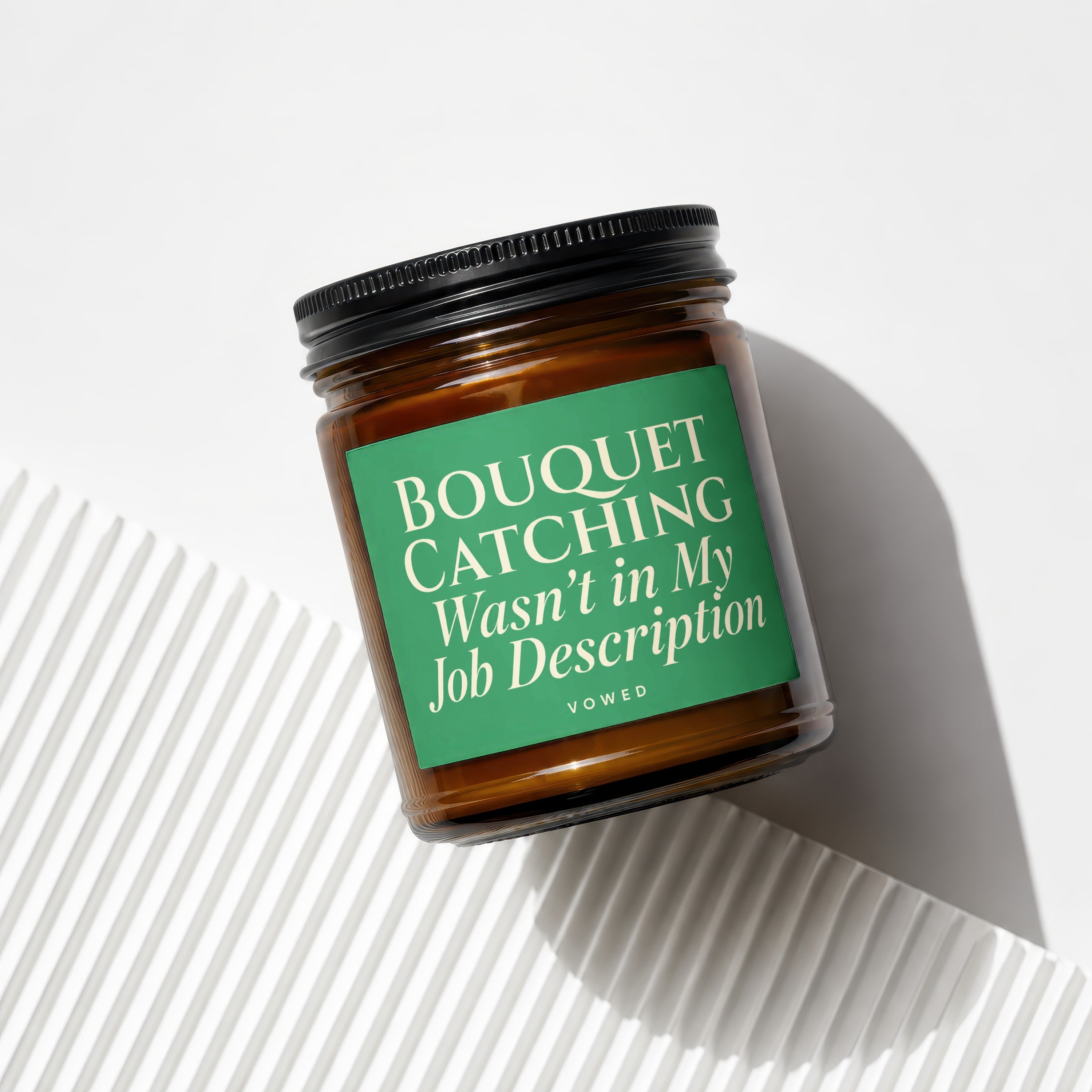 Amber candle in jar with green label reading "BOUQUET CATCHING Wasn't in My Job Description".