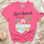 Pink t-shirt with "Last Splash Sarah's Bach" text and beach scene graphic.