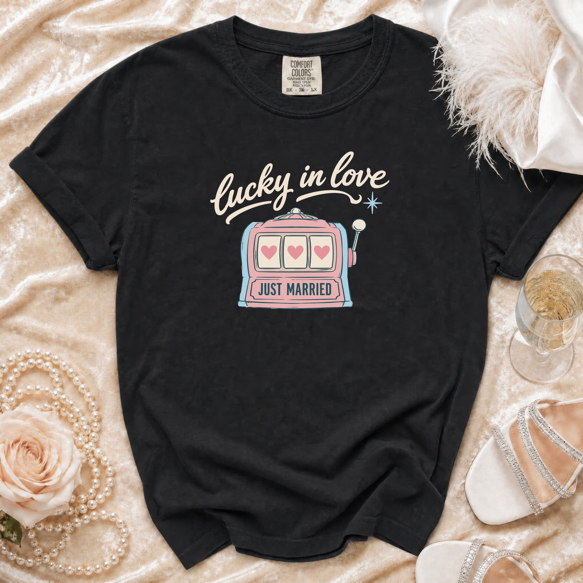 Black t-shirt with "lucky in love" and "just married" text, featuring a slot machine graphic.