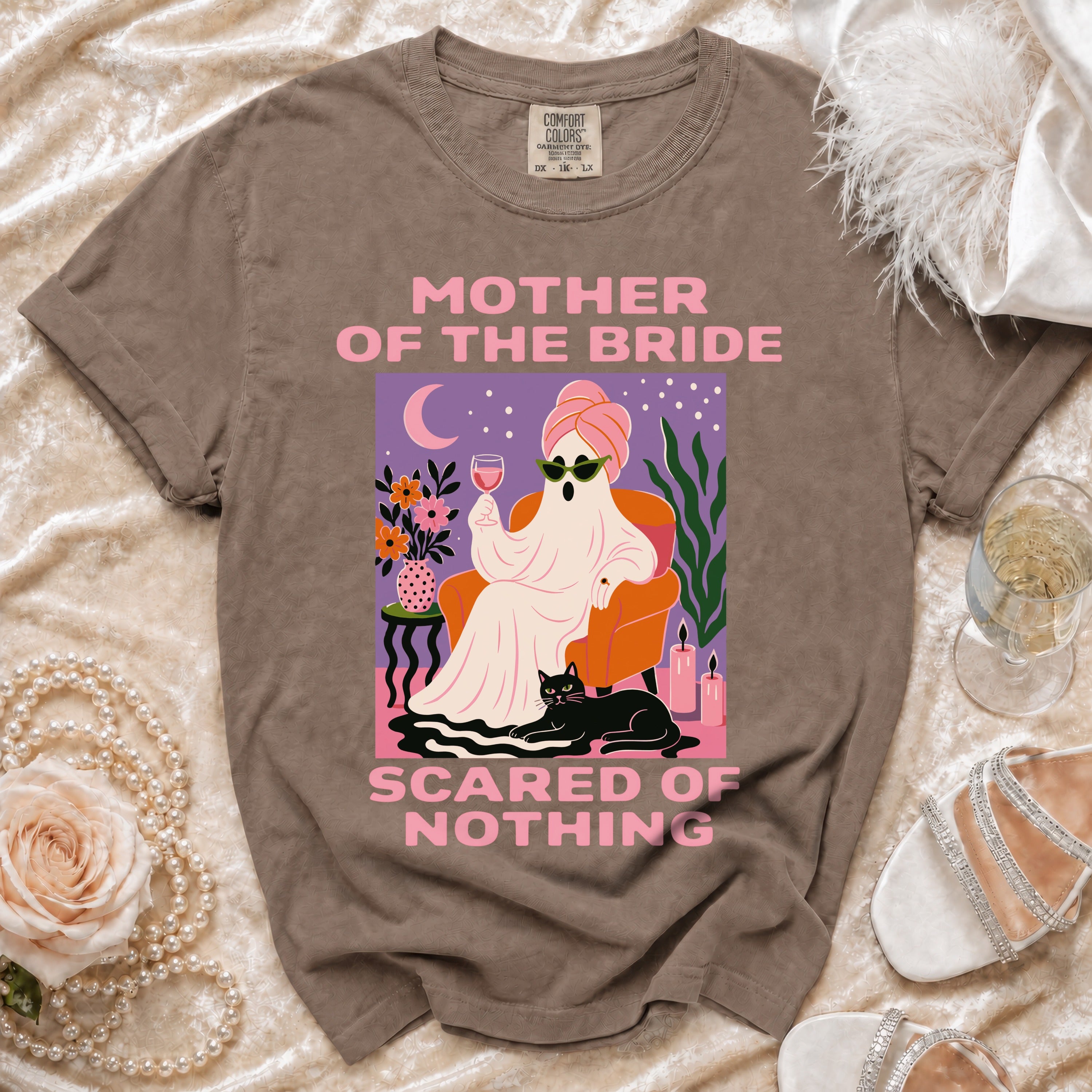 Brown t-shirt with "Mother of the Bride Scared of Nothing" graphic.