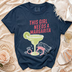 Navy t-shirt with "This girl needs a margarita" text and a margarita graphic.