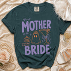 Dark teal t-shirt with "Official Mother of the Bride" design and Halloween motifs.