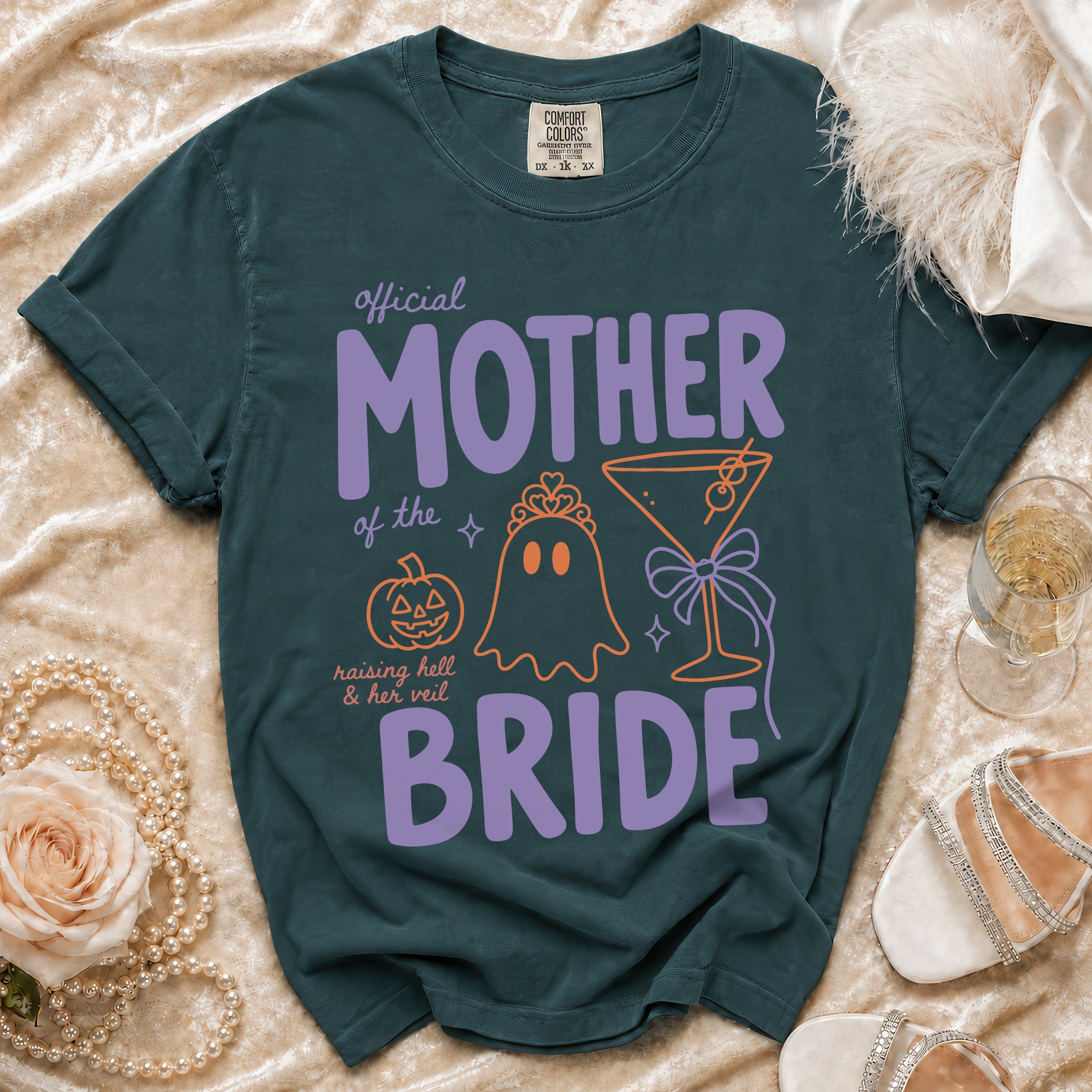 Dark teal t-shirt with "Official Mother of the Bride" design and Halloween motifs.