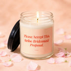 Candle with text "Please Accept This Bribe Bridesmaid Proposal." with lit wick.