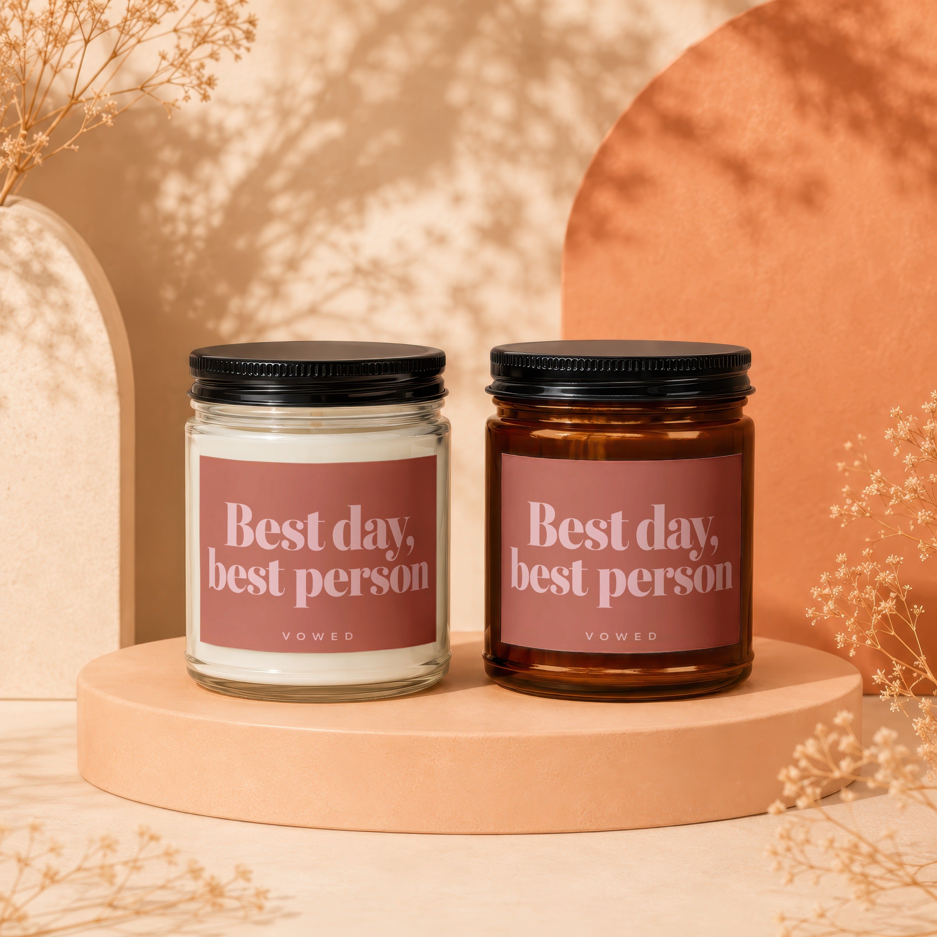 Two candles, one clear and one amber glass, with "Best day, best person" text.