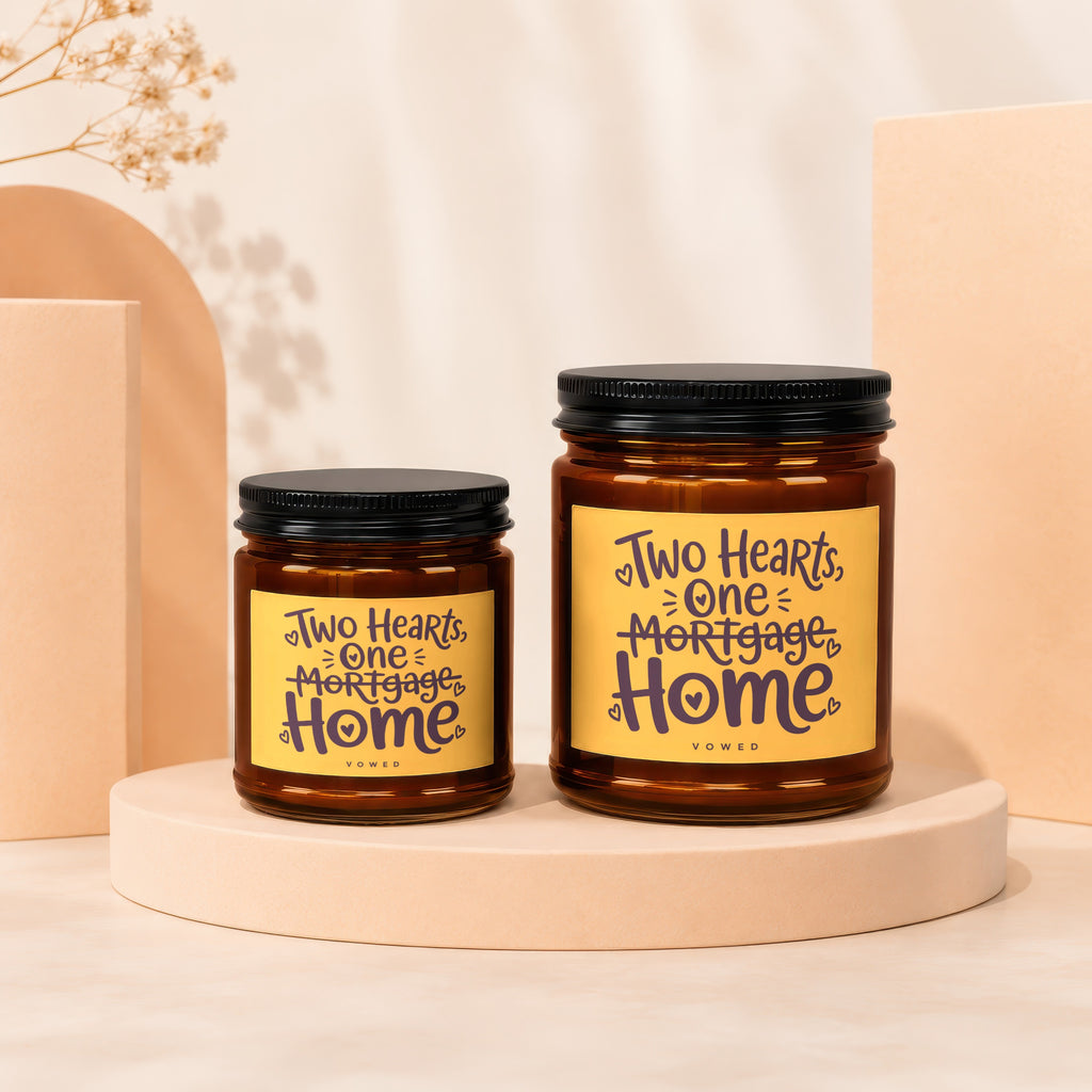Two candles with "Two Hearts, One Mortgage Home" text on yellow labels.