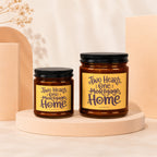 Two candles with "Two Hearts, One Mortgage Home" text on yellow labels.
