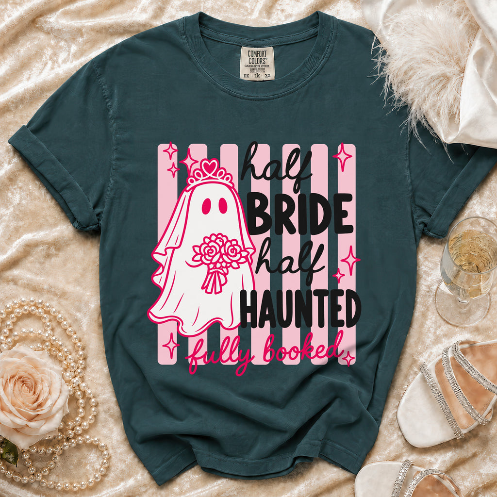 Teal t-shirt with a ghost bride graphic reading "half bride, half haunted, fully booked."