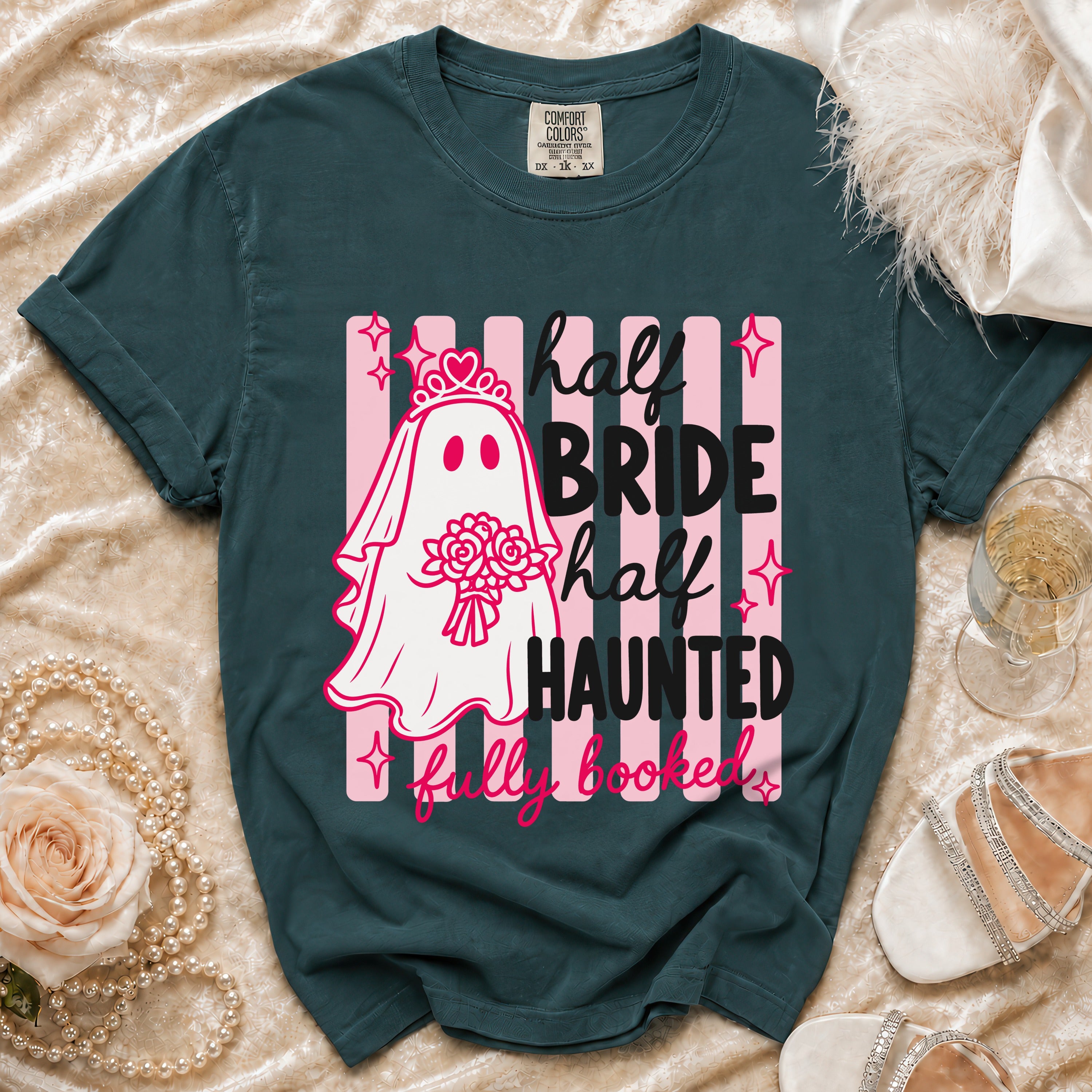 Teal t-shirt with a ghost bride graphic reading "half bride, half haunted, fully booked."