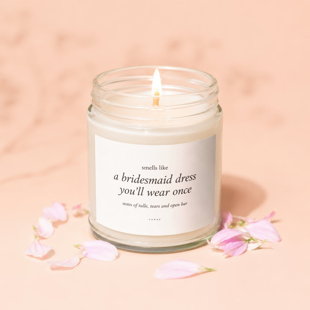 Candle with text "smells like a bridesmaid dress you'll wear once".