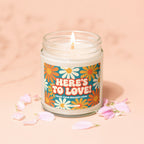 Glass jar candle with lit wick and "HERE'S TO LOVE! FROM YOUR BIGGEST FANS" text.
