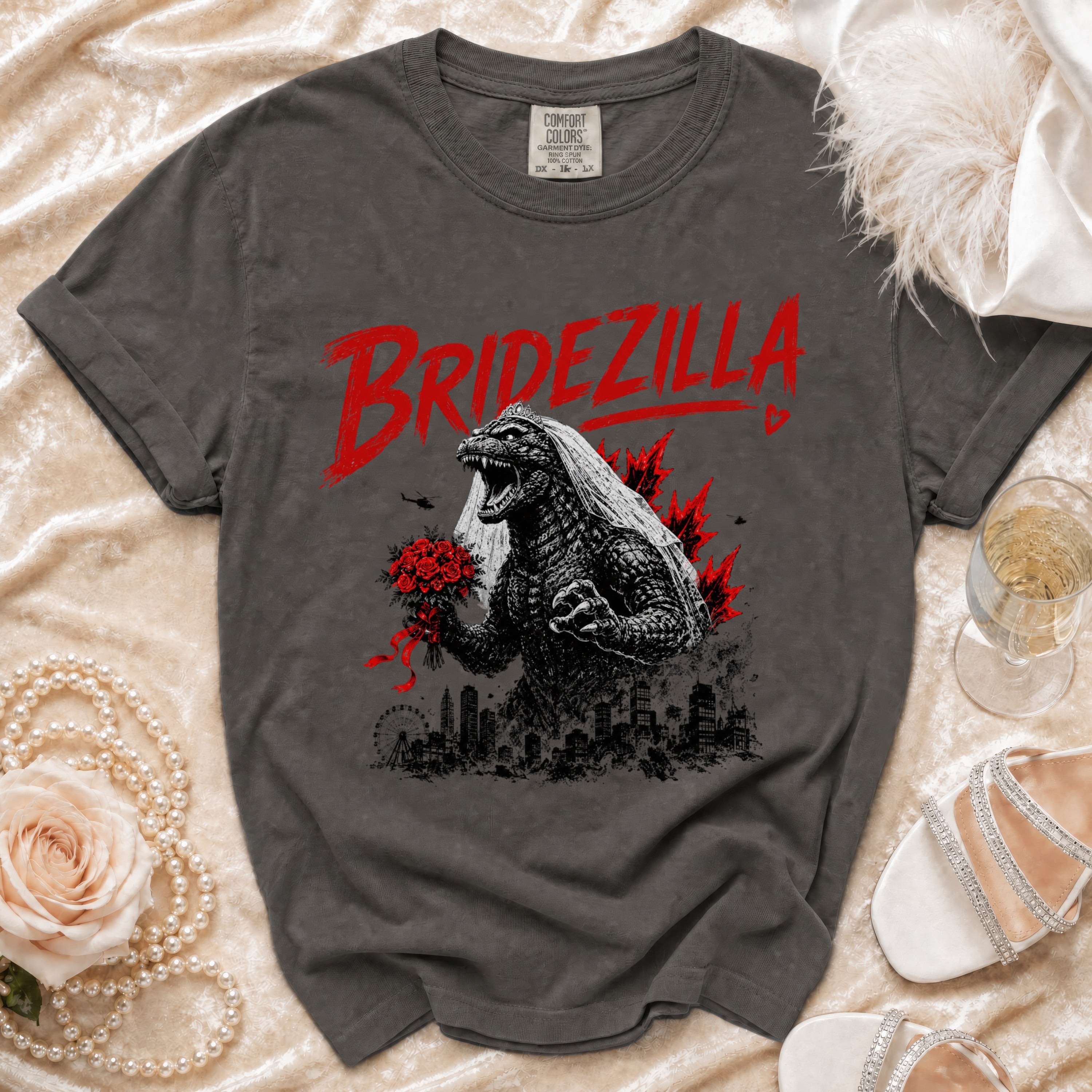 Dark grey t-shirt with "BRIDEZILLA" text and Godzilla wearing a veil holding flowers.