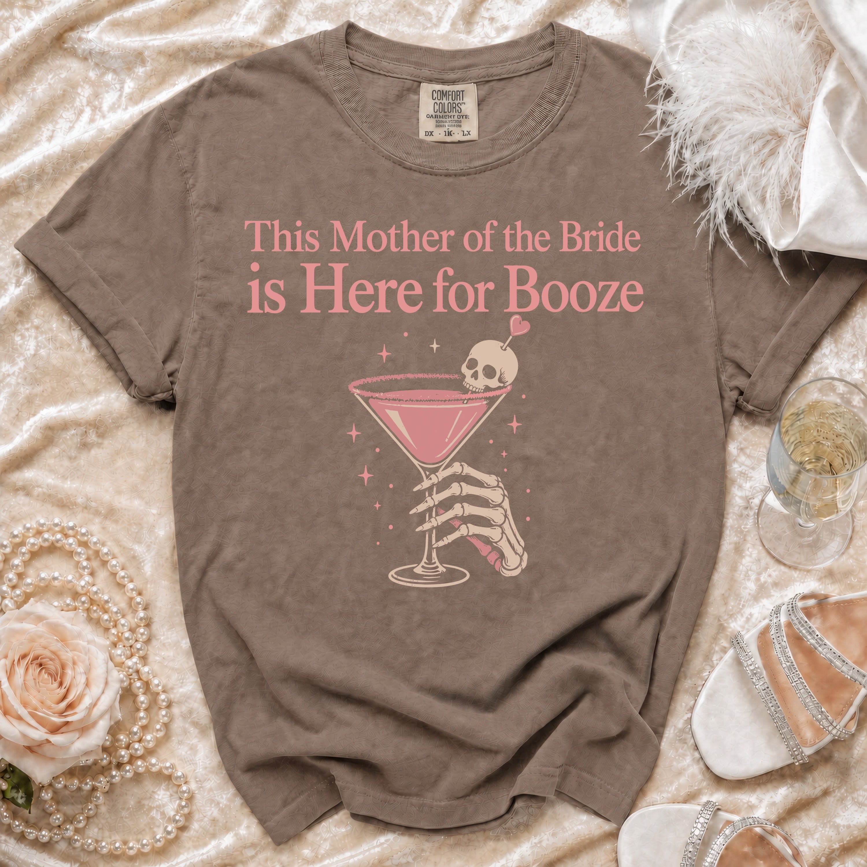 Brown t-shirt with "This Mother of the Bride is Here for Booze" graphic.