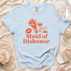 Light blue t-shirt with orange "Maid of Dishonor" text, flowers, lips, and champagne glasses.