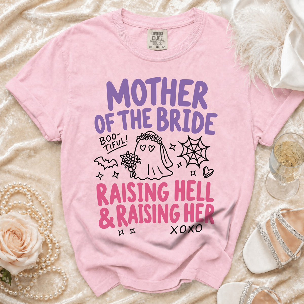 Pink t-shirt with "Mother of the Bride" and "Raising Hell & Raising Her" text.