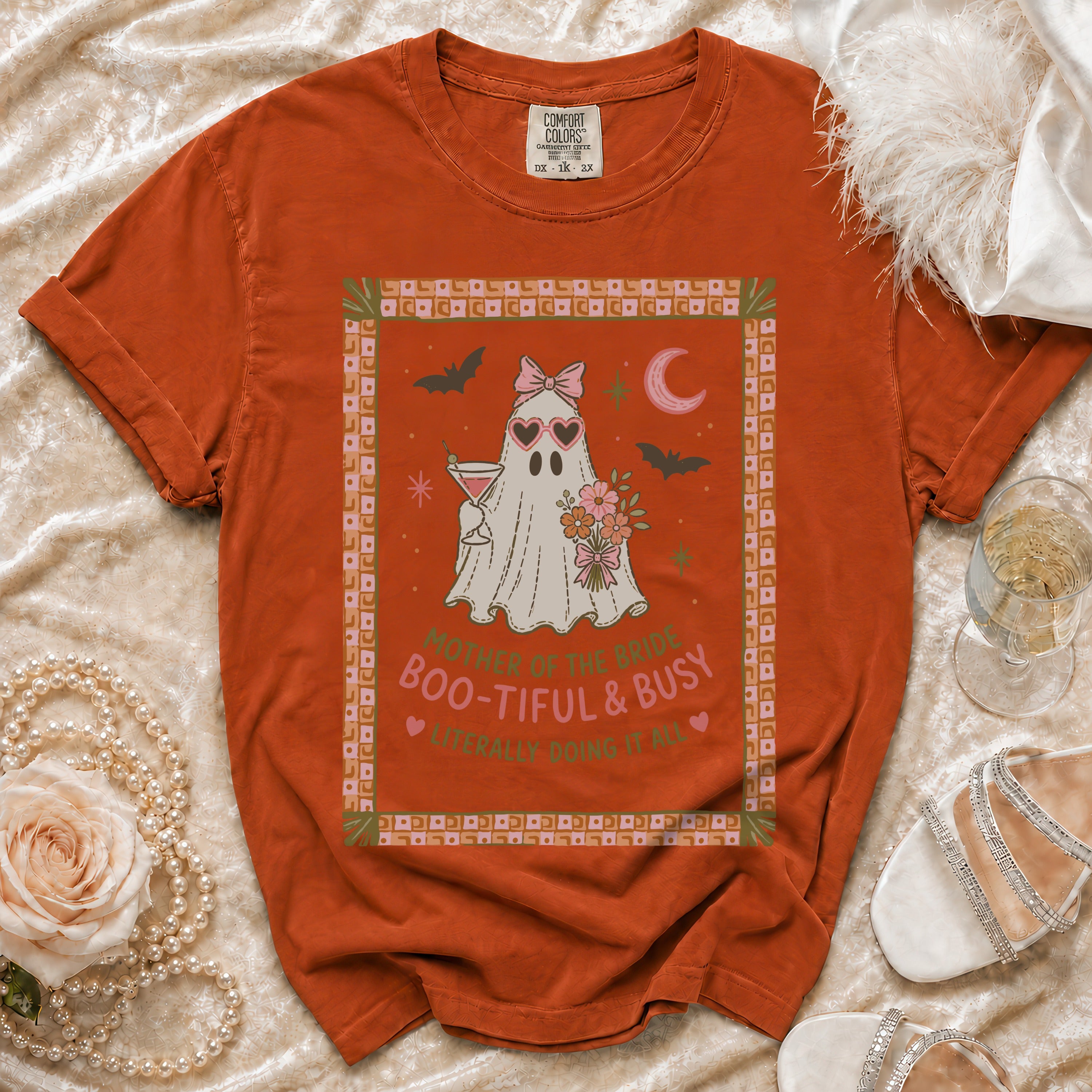 Orange Comfort Colors t-shirt with a ghost graphic reading "Mother of the Bride Boo-tiful & Busy."