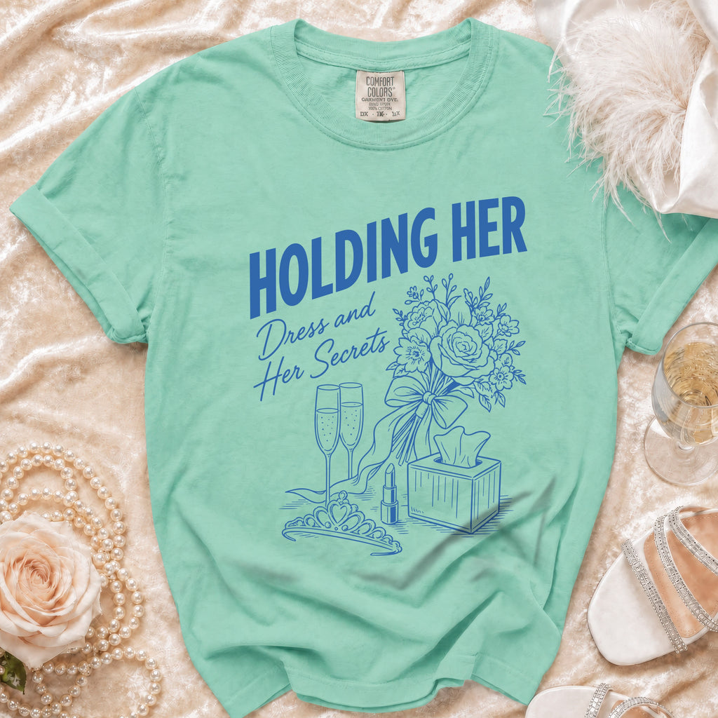 Mint green t-shirt with "Holding Her Dress and Her Secrets" graphic.