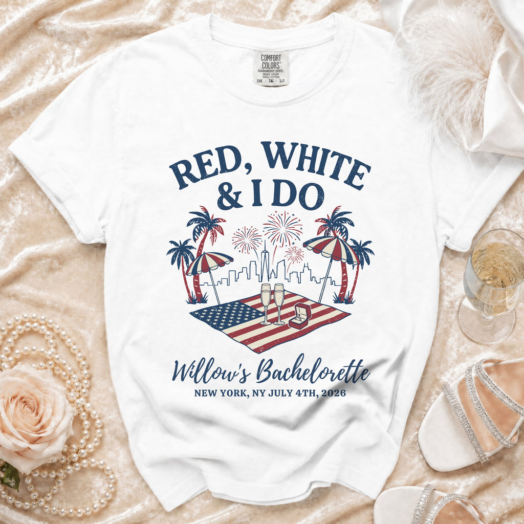 White t-shirt with "Red, White & I Do" text, American flag, fireworks, and palm trees.