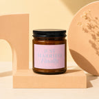Amber glass candle with "JUST MARRIED. Finally." and "VOWED" on pink label.