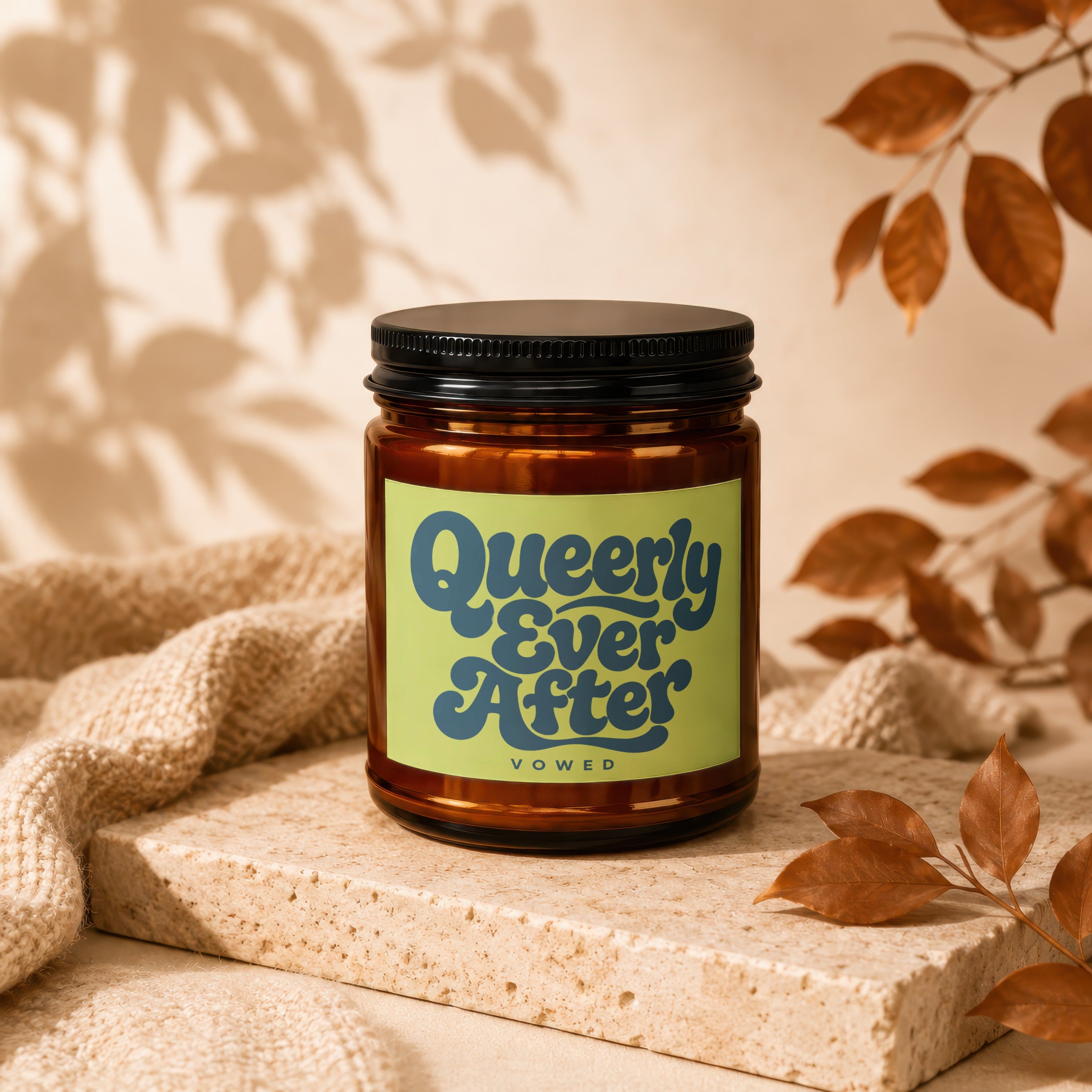 Amber jar candle with "Queerly Ever After VOWED" text on a light green label.