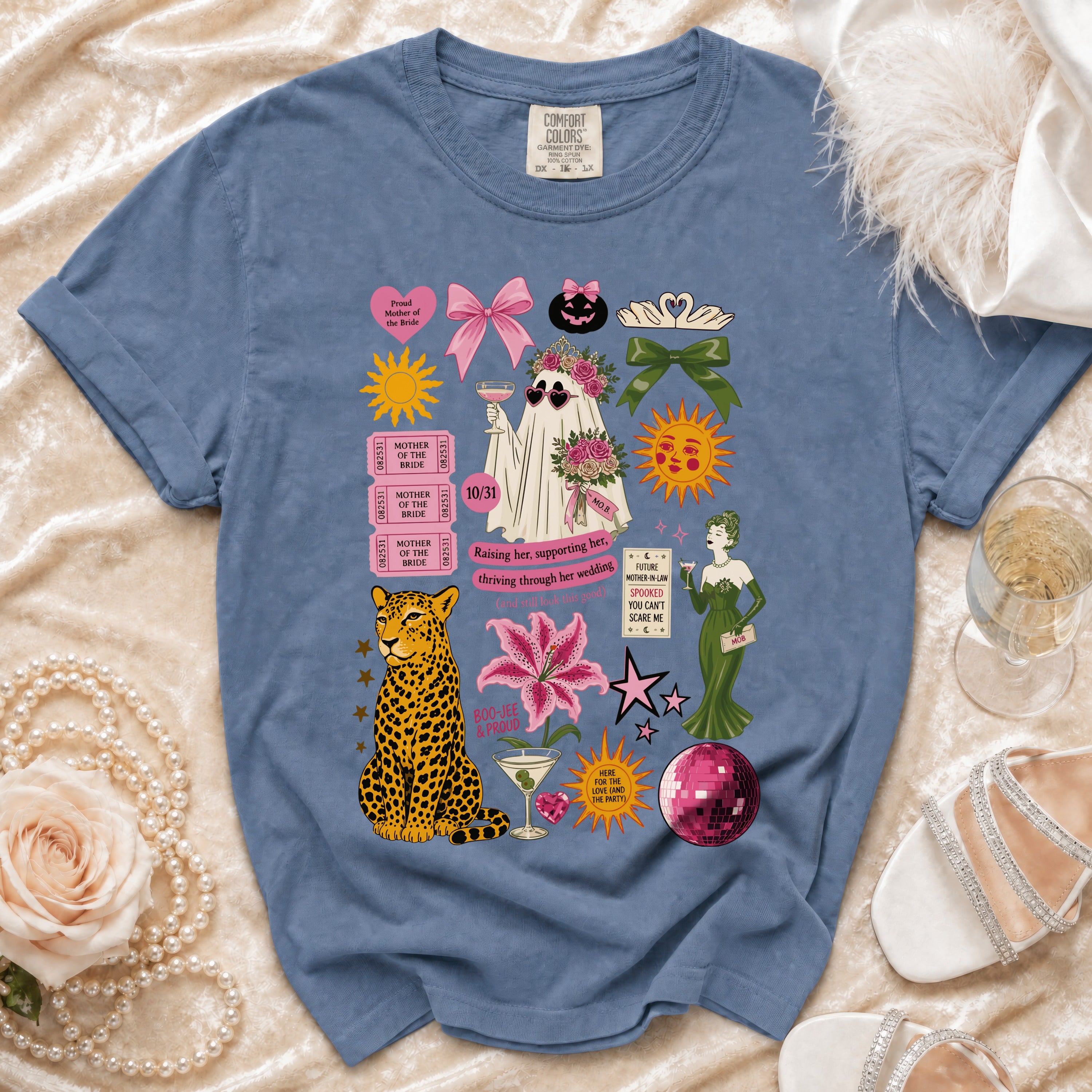 Blue t-shirt with "Mother of the Bride" graphics including a ghost bride, leopard, and flowers.