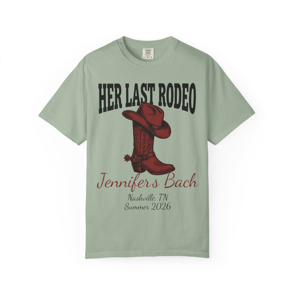 Green t-shirt with "Her Last Rodeo" text, cowboy boot, and event details.