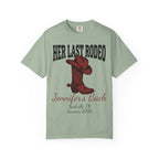 Green t-shirt with "Her Last Rodeo" text, cowboy boot, and event details.