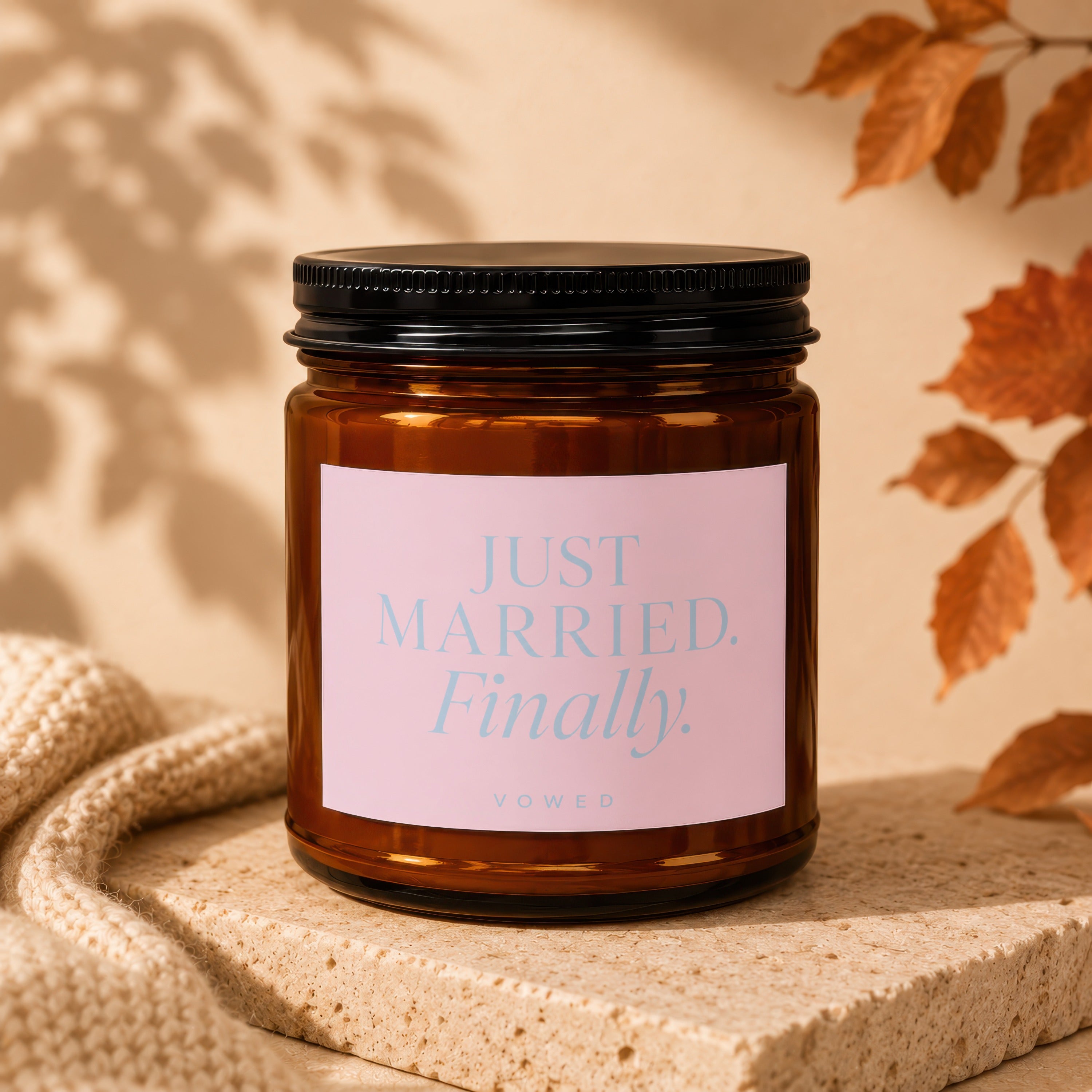 Amber candle with pink label reading "JUST MARRIED. Finally."