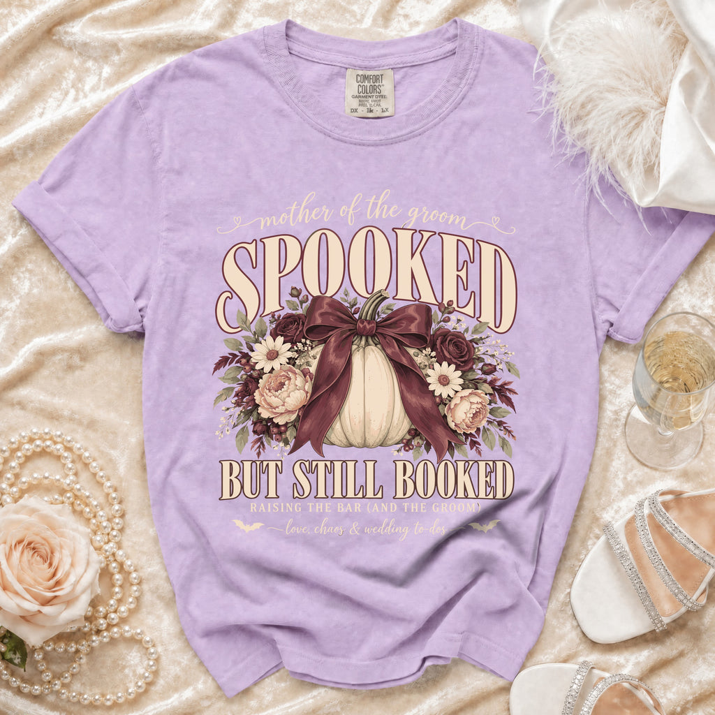 Purple t-shirt with "mother of the groom SPOOKED BUT STILL BOOKED" graphic.