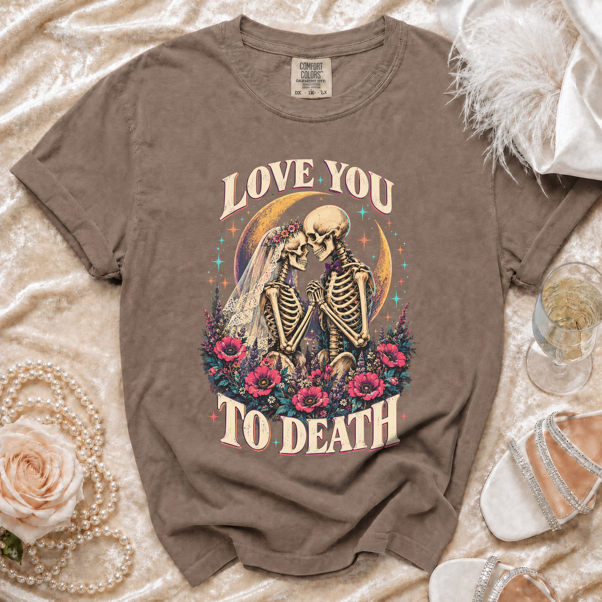 T-shirt with skeletons in wedding attire and flowers, text "LOVE YOU TO DEATH".