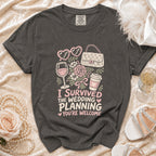 Graphic t-shirt with "I Survived The Wedding Planning You're Welcome" text.