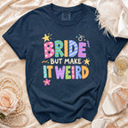 Navy t-shirt with "Bride But Make It Weird" text and playful graphics.