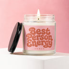 Glass jar candle with pink label reading "Best Person Energy" and "VOWED".