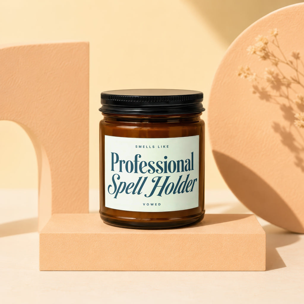 Amber candle in jar with black lid labeled "Professional Spell Holder"