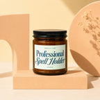Amber candle in jar with black lid labeled "Professional Spell Holder"