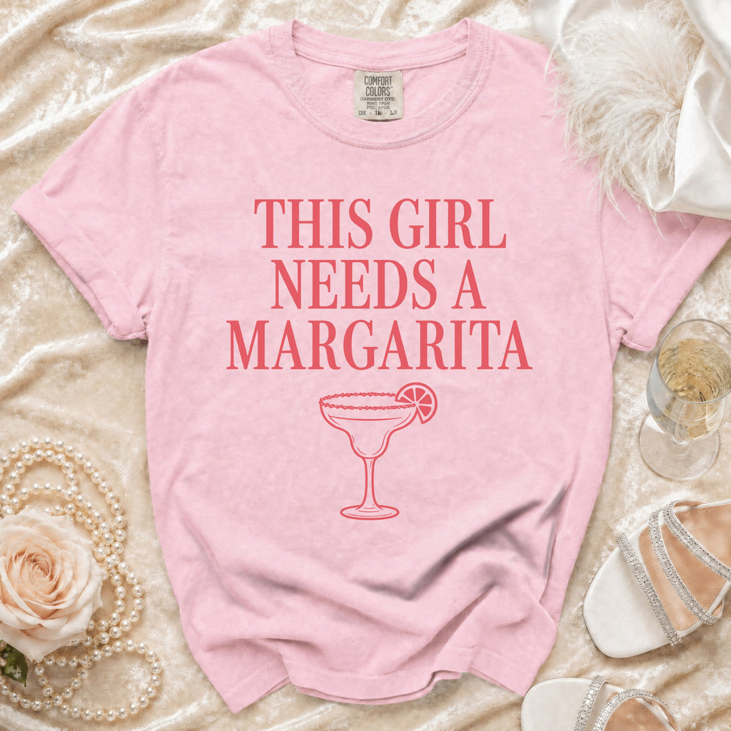 Pink t-shirt with "This girl needs a margarita" text and margarita graphic.