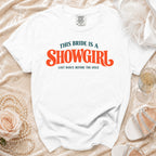 White t-shirt with text "THIS BRIDE IS A SHOWGIRL LAST DANCE BEFORE THE AISLE".