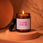 Candle with pink label saying "IT'S GIVING FUTURE MRS."