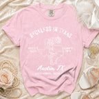 Pink t-shirt with "Reckless in Texas" and disco cowgirl graphics.