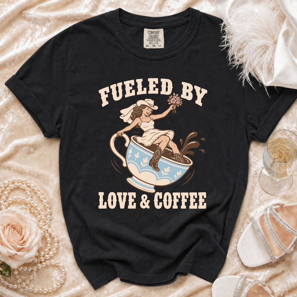 Black t-shirt with "Fueled By Love & Coffee" graphic of bride in cowboy hat on coffee cup.