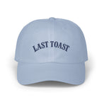 Light blue baseball cap with embroidered navy text "LAST TOAST"