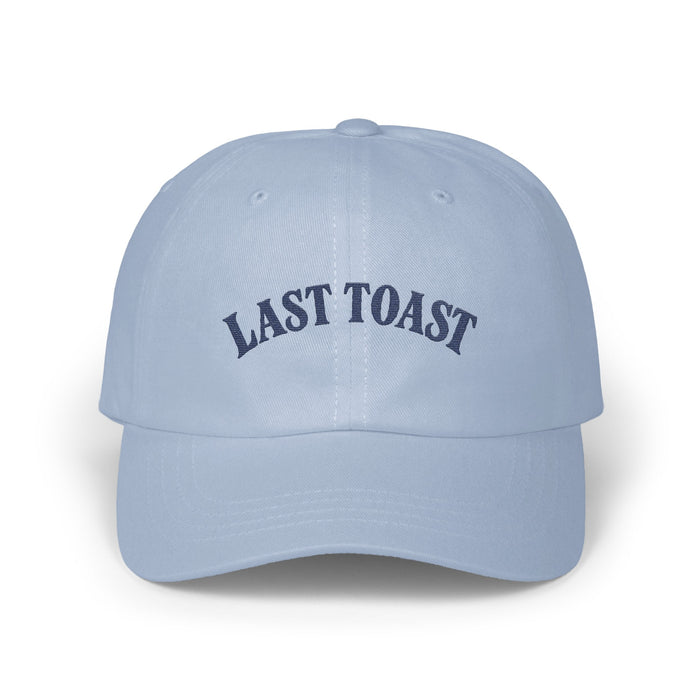 Light blue baseball cap with embroidered navy text "LAST TOAST"