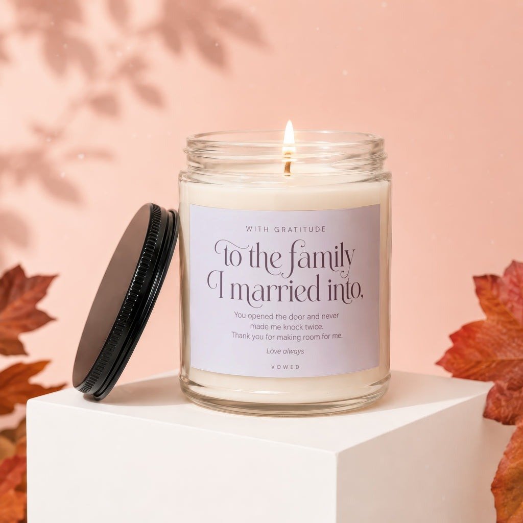Candle with label "To the family I married into" in a glass jar.