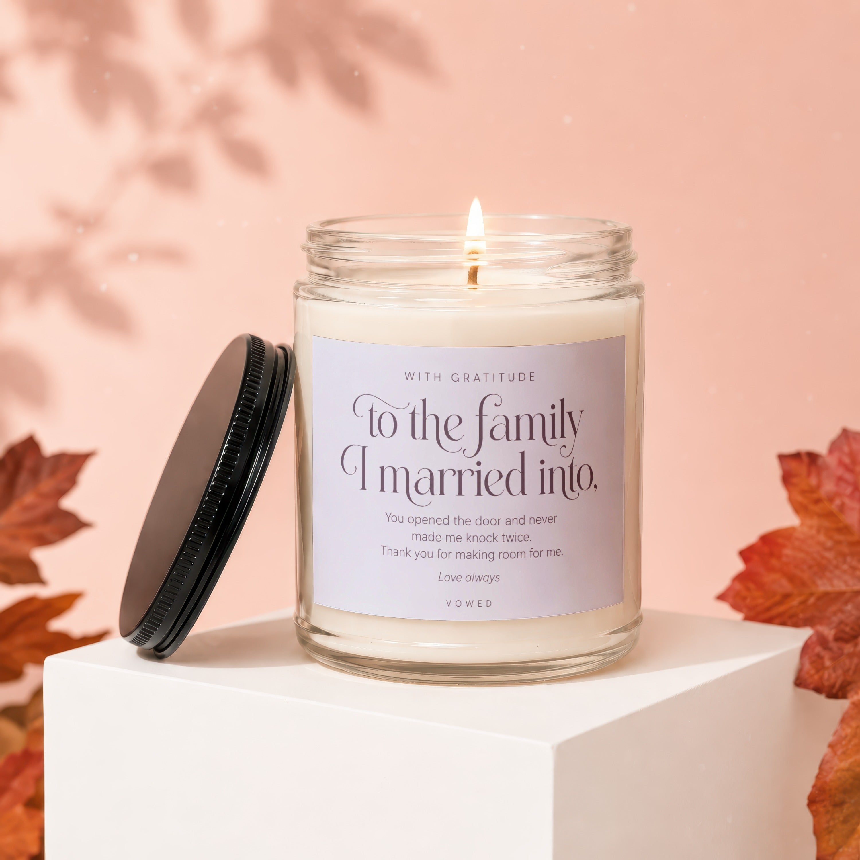 Candle with label "To the family I married into" in a glass jar.